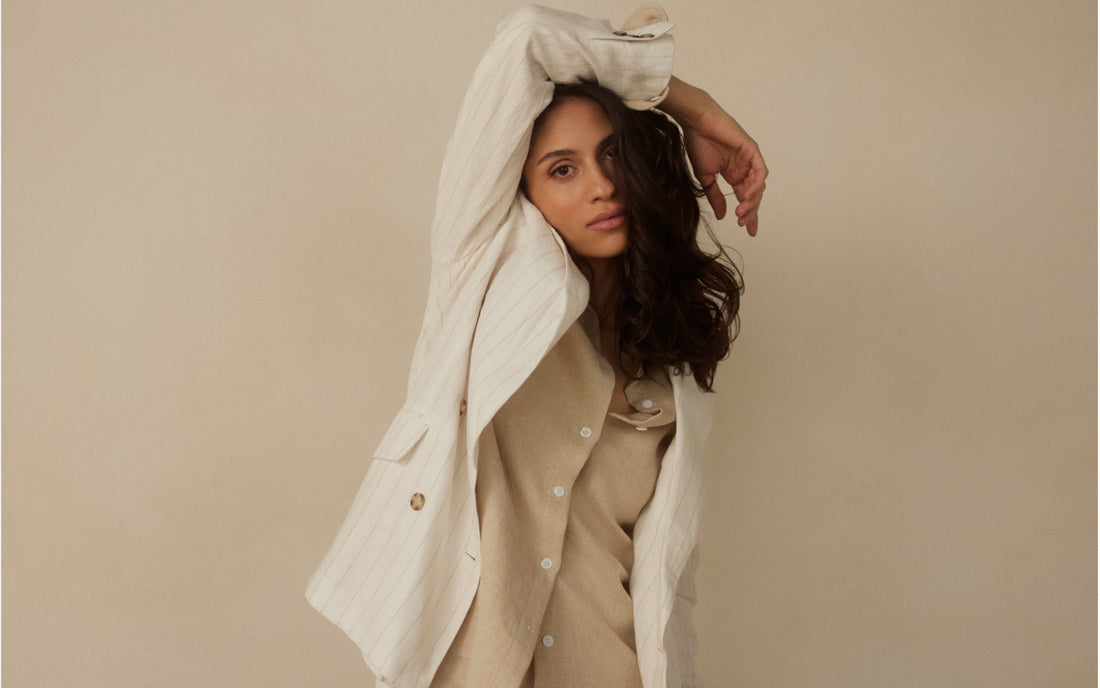 Woman wearing tailored linen by Whitney Linen, styled for warm weather travel and packing